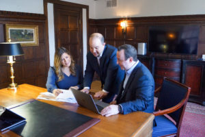 Attorneys in office with client